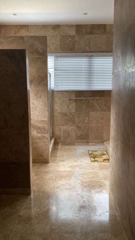 Luxurious bathroom with stone tile walk-in shower and large vanity PH La Toscana Costa del Este