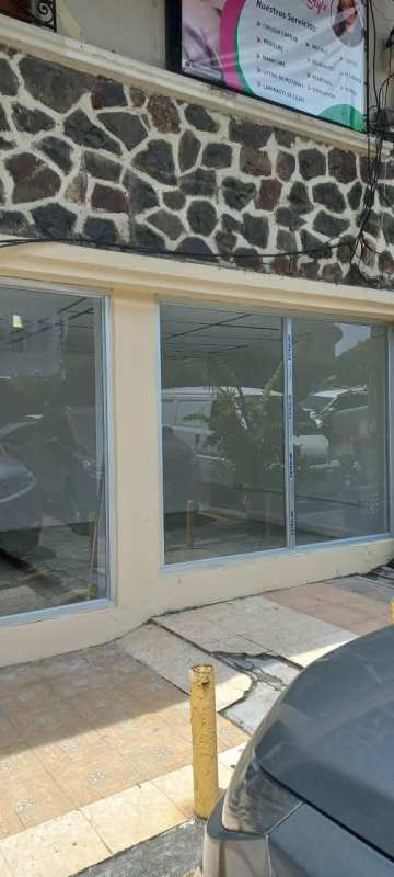 Commercial storefront with large glass window and security grilles in Bella Vista Panama