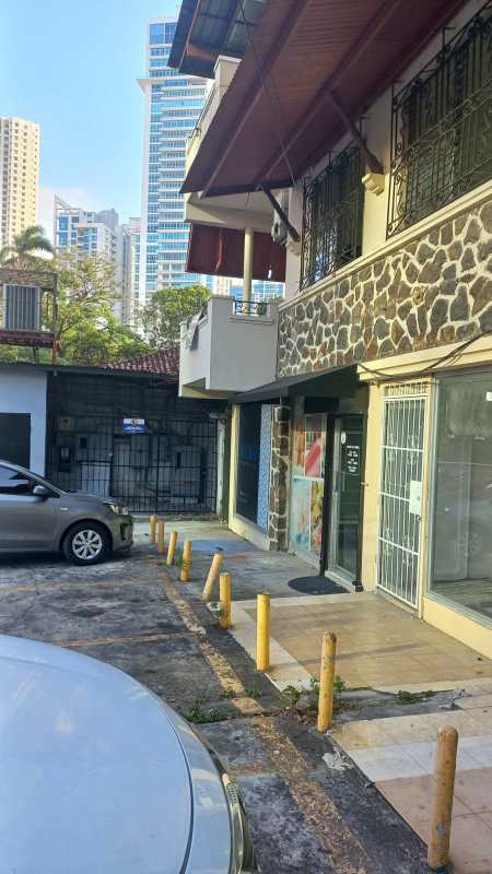 Two-story commercial mixed building with parked cars and street scene Bella Vista Panama