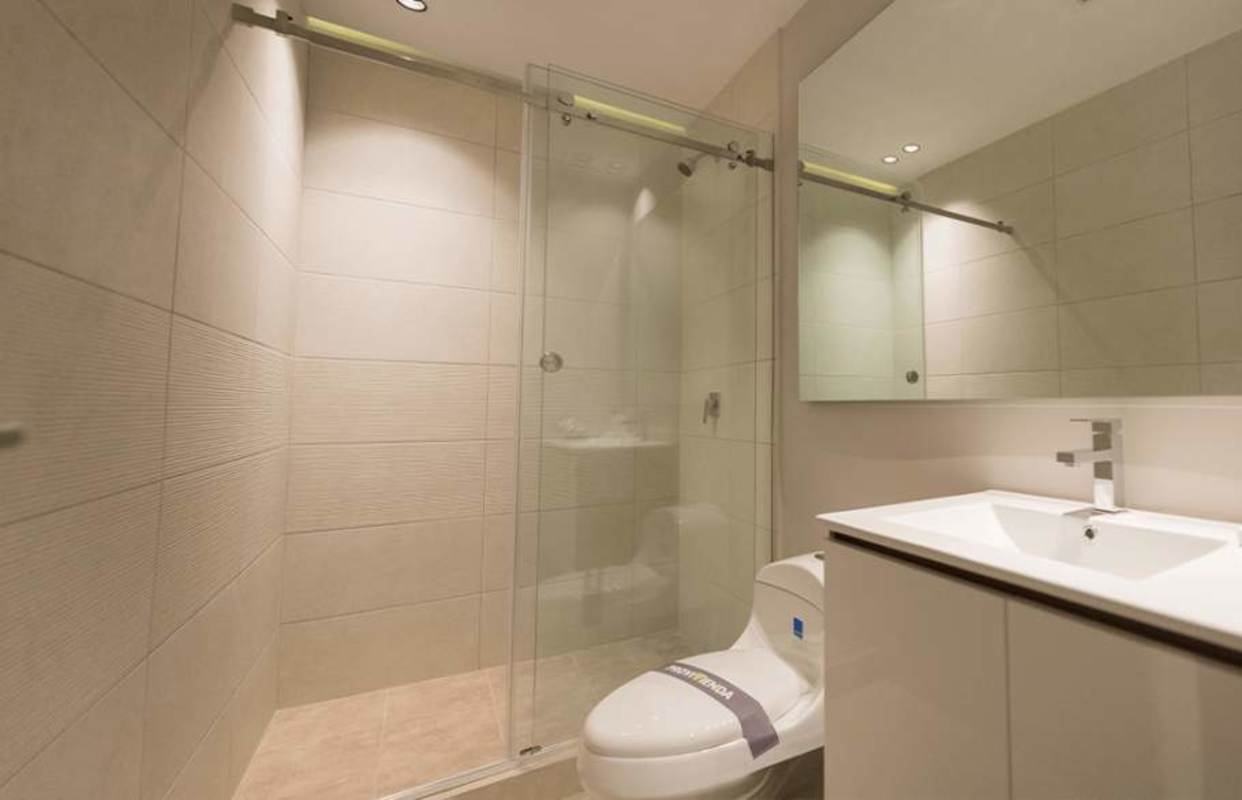 Minimalist bathroom with beige tiles glass shower PH URBAN El Cangrejo Panama