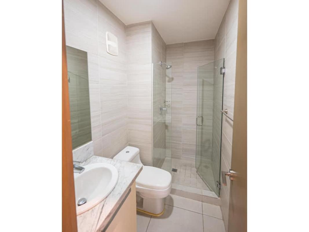 Contemporary bathroom with glass shower, mirror, marble counter in PH Park City Panama