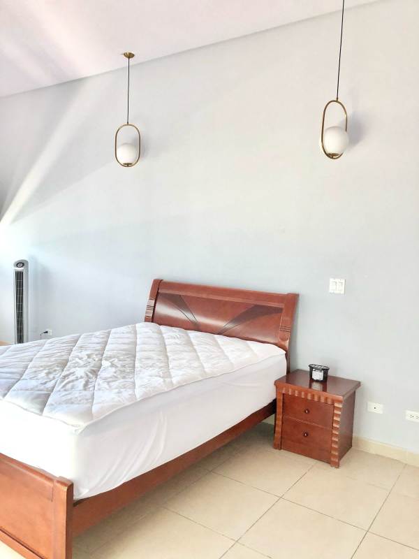 Contemporary kitchen with wooden cabinets and cream countertops PH Oasis Punta Pacifica