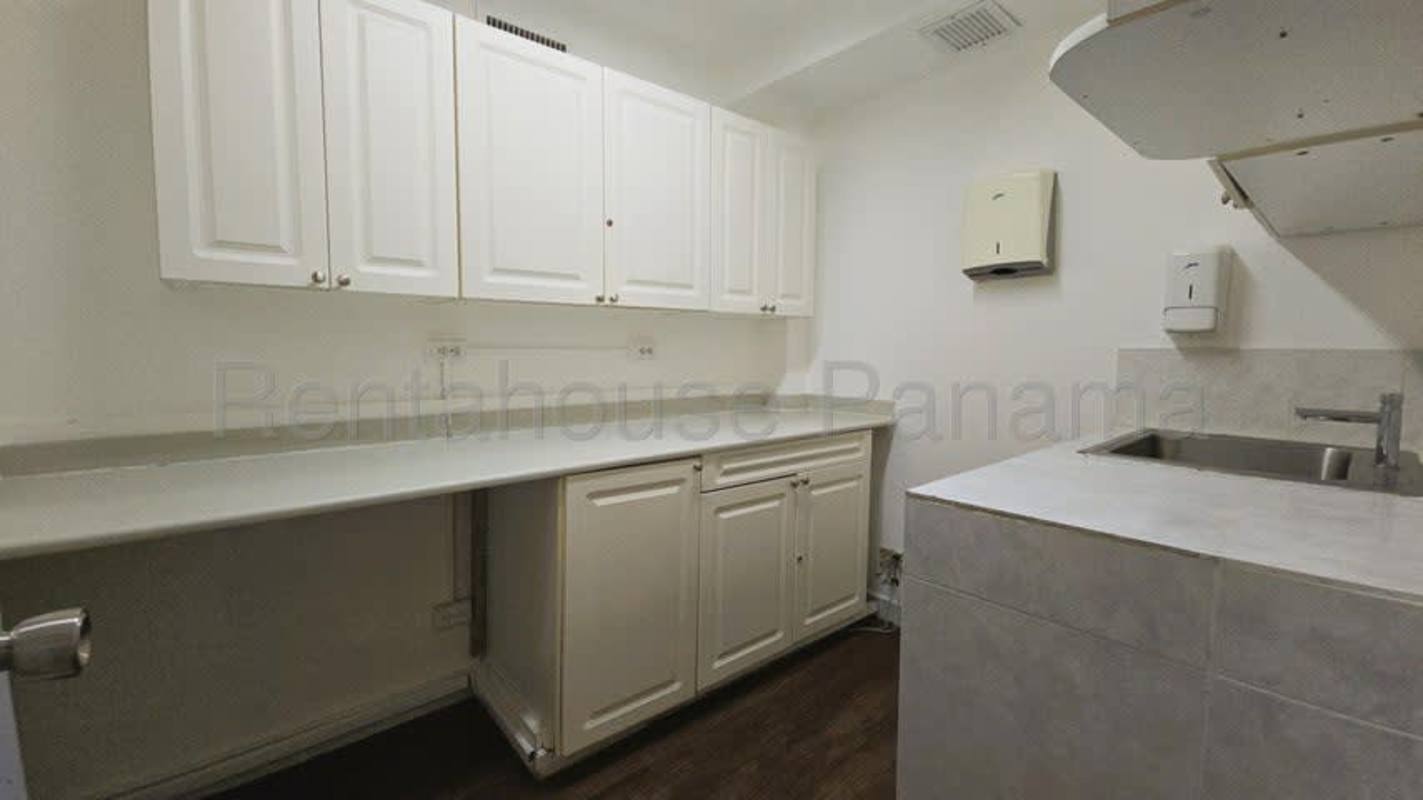 Modern glass-partition office space with city view windows and carpet tiles in Marbella Panama