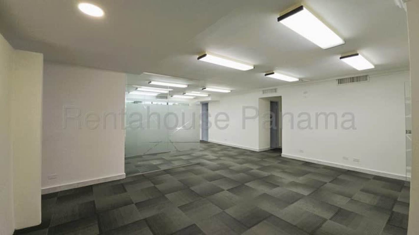 Office corridor with frosted glass walls, recessed lighting, carpet tile in PH Marbella Business Center Panama City