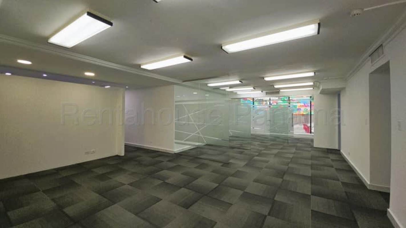 Basic office restroom with pedestal sink, toilet, beige tile wall Marbella Business Center Panama