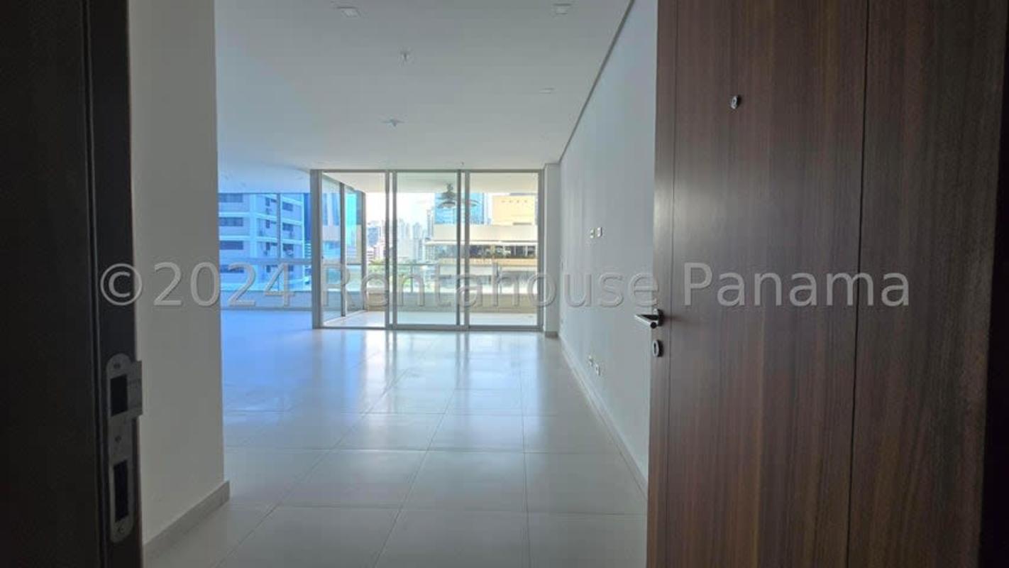 Large open living and dining area with floor-to-ceiling windows in PH Marbella Tower apartment Panama City