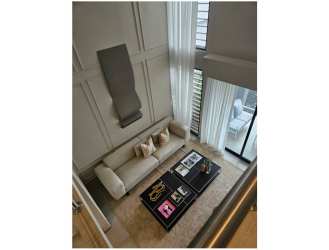 Bright living room with tall ceilings, large windows, floor-to-ceiling curtains, modern design at Alere Panama Pacifico