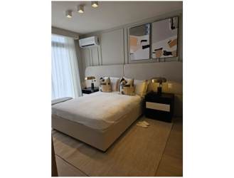 Contemporary bedroom with large window, upholstered bed, wall art, AC in Alere Panama Pacifico new house