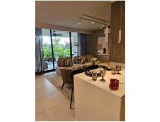 Modern open living and dining with sliding doors to gardens, stylish furnishings at Alere Panama Pacifico