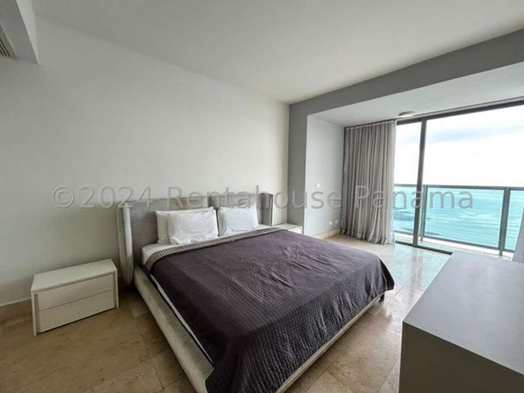 Luxurious master bedroom with ocean views, panoramic windows, king bed at PH Yoo Panama Avenida Balboa