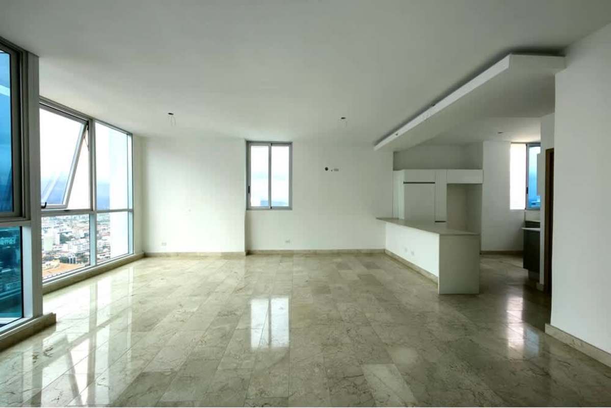 Bright open-plan living and kitchen with marble floors, floor-to-ceiling windows, city views in Bella Vista Panama