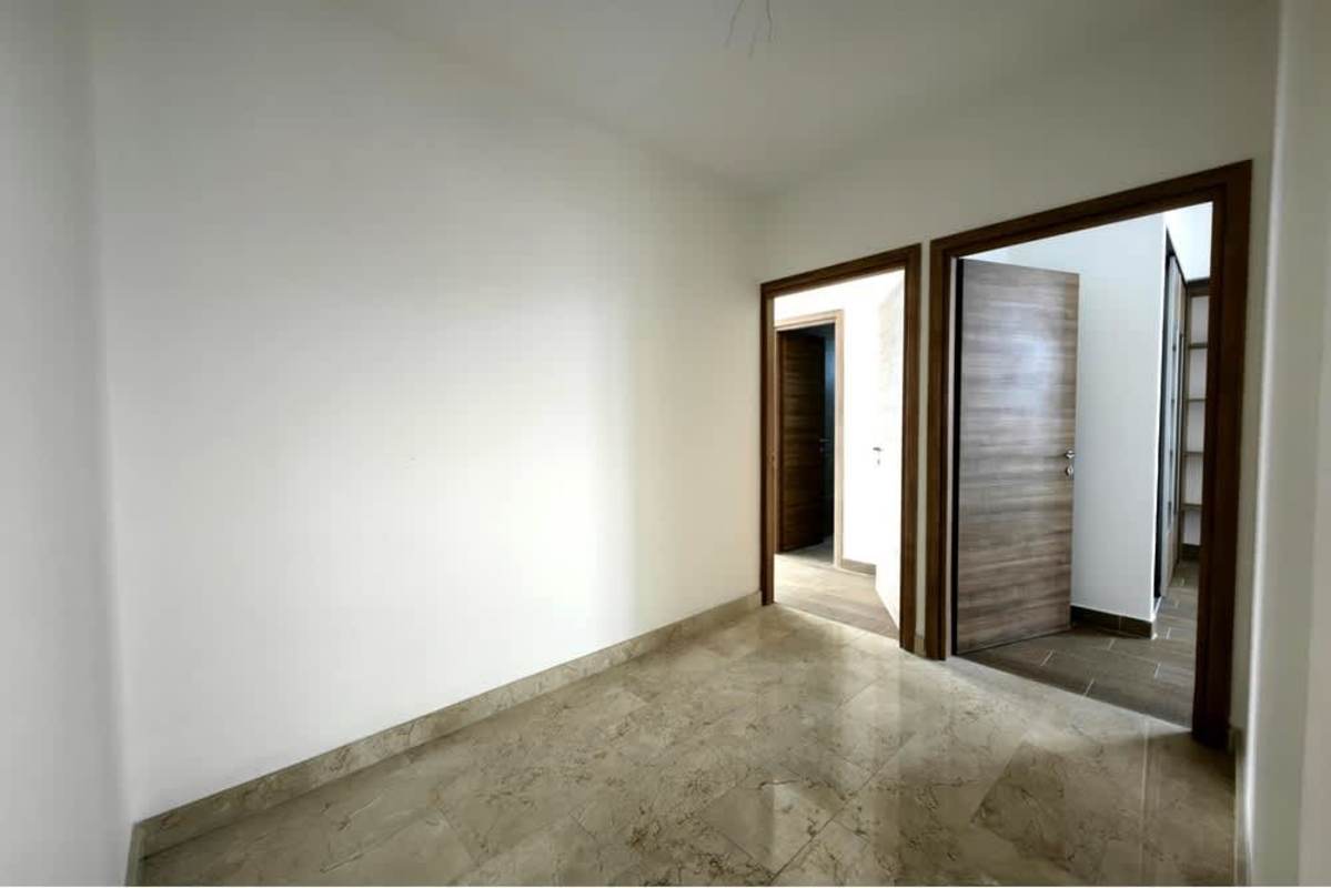 Wide luxury hallway with marble flooring and recessed lighting in penthouse