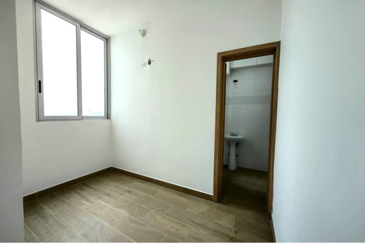 Small bedroom with attached bathroom and city views in Bella Vista penthouse