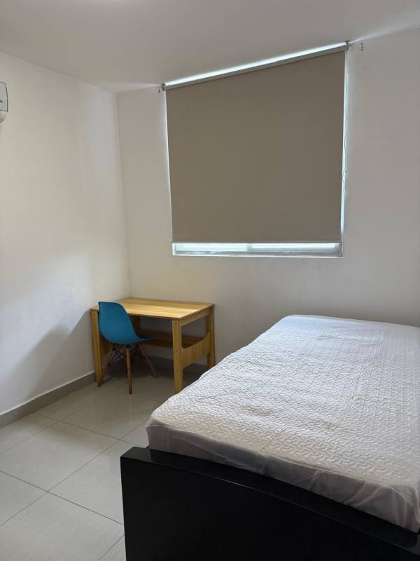 Furnished bedroom featuring study desk, bed, AC, natural light in PH San Francisco Bay apartment rental