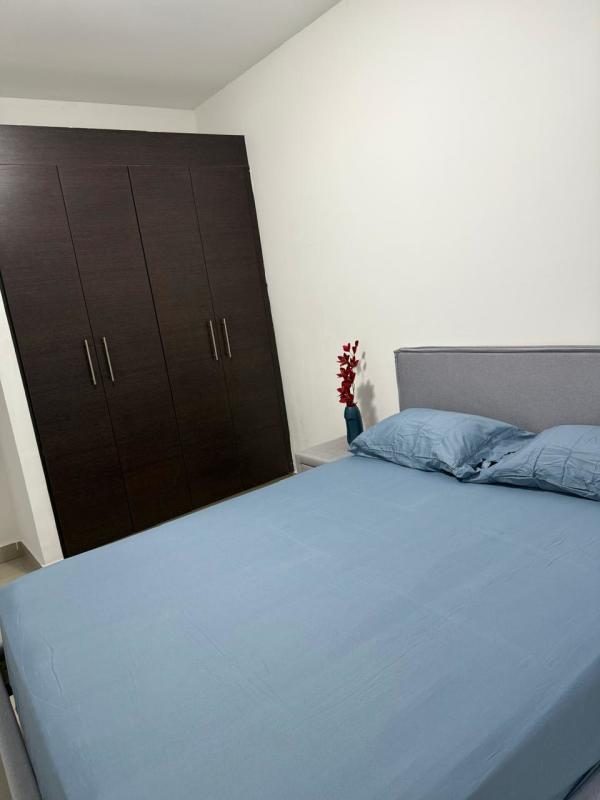 Bedroom with blue linens, large wardrobe, minimalist design in PH San Francisco Bay rental
