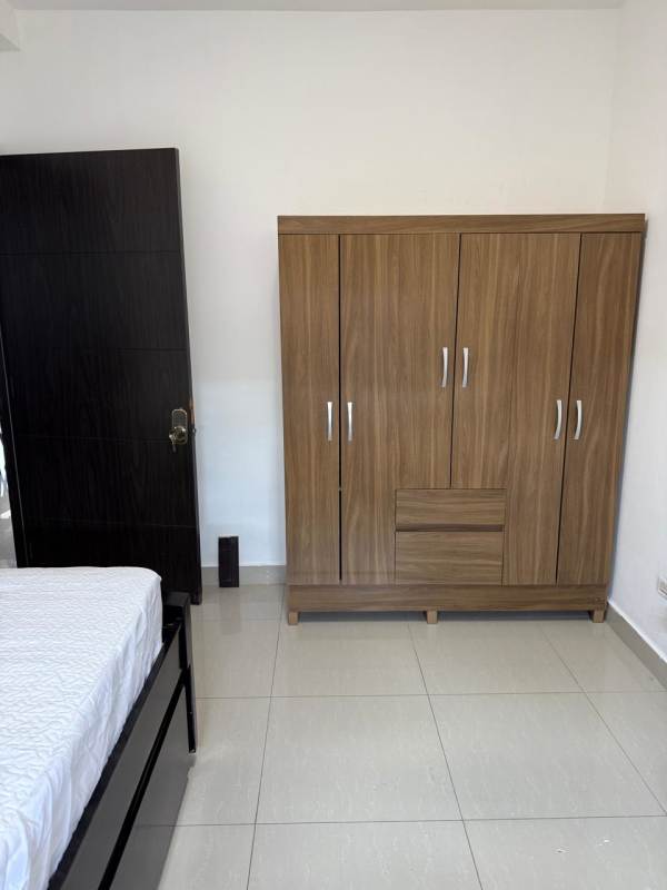 Bedroom with wooden wardrobe, white walls, minimalist decor in PH San Francisco Bay rental