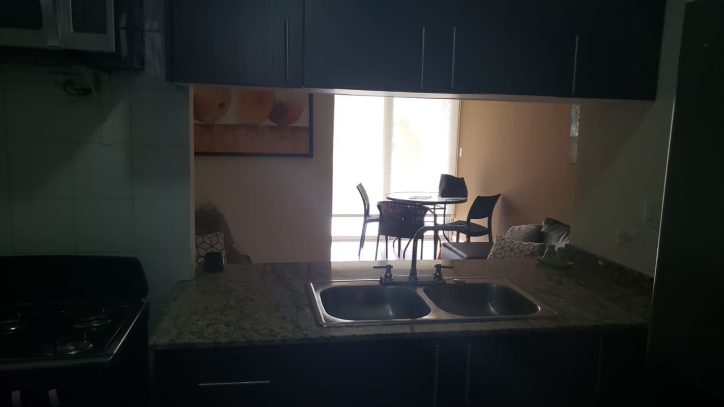 Kitchen pass-through opening onto dining in Cosmopolitan Tower Panama City furnished rental