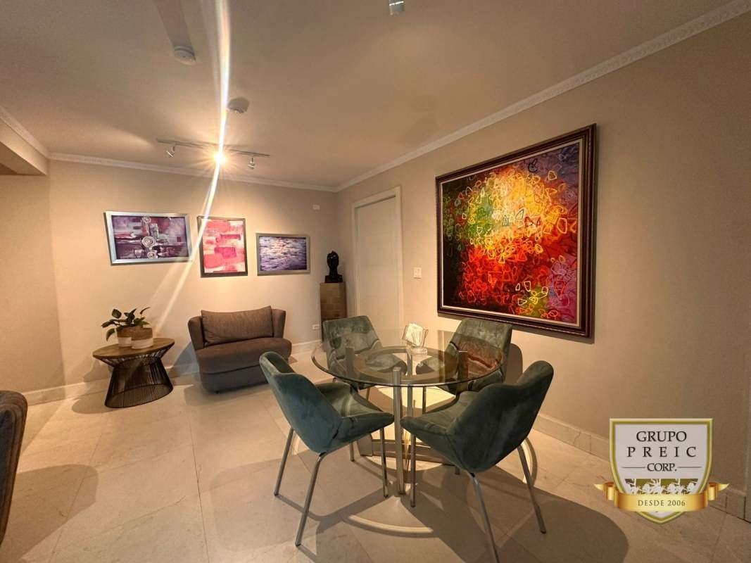 Dining area with glass table, modern decor adjacent to living space in PH El Cangrejo Imperial Panama