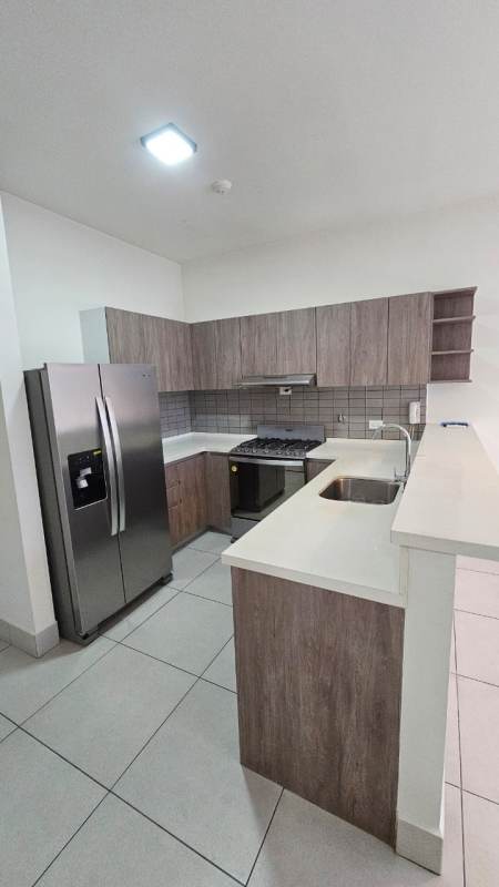 Modern open kitchen with stainless appliances and tile backsplash PH Coco Place Panama