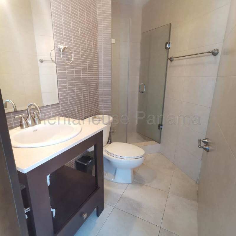 Modern bathroom with glass shower, sink vanity and ceramic tiles in Costa del Este apartment