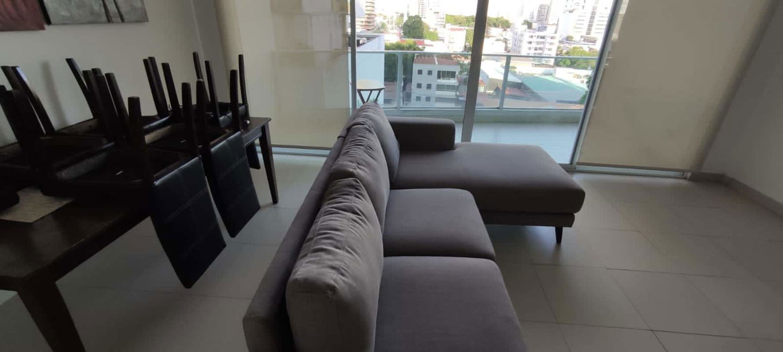Living room with floor-to-ceiling windows and city view balcony PH Cosmopolitan Panama City