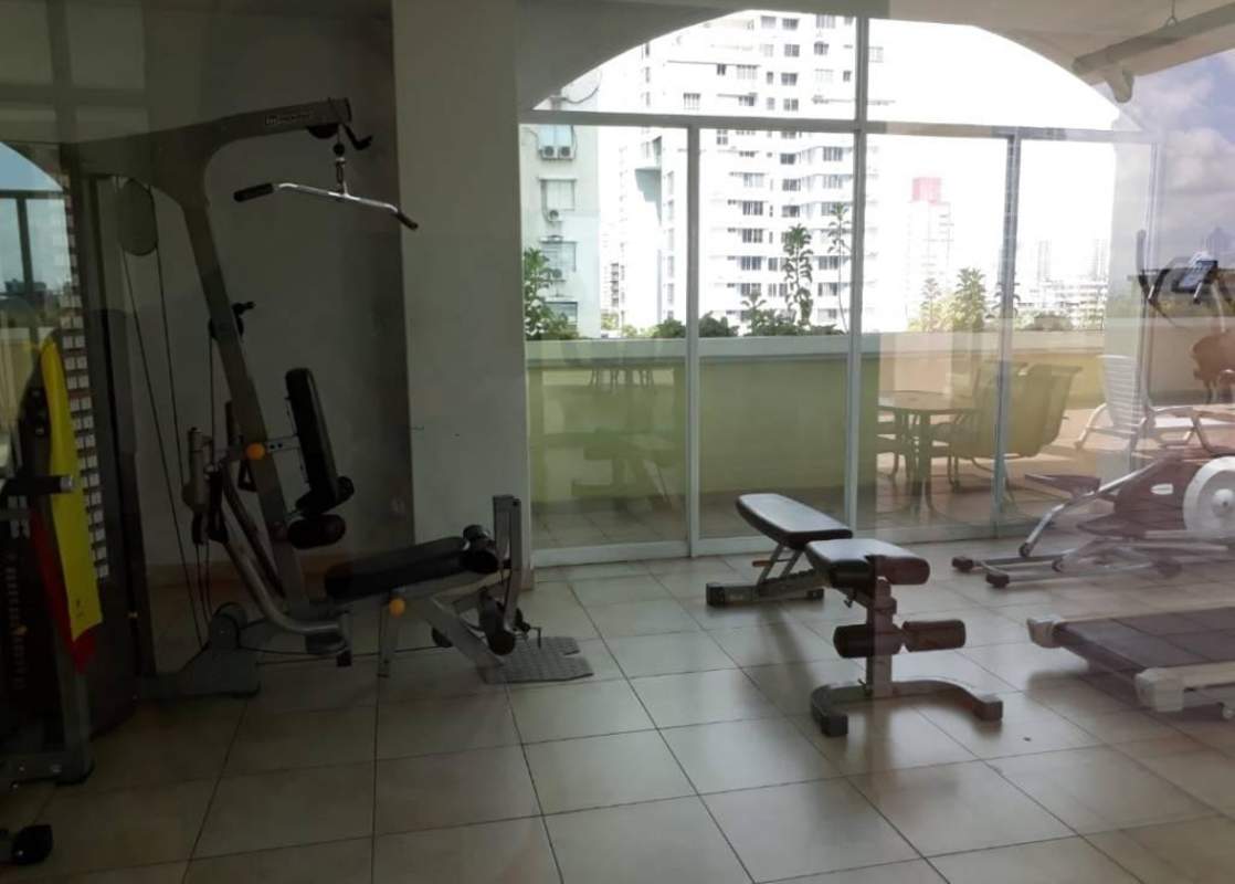 Modern gym with fitness machines large windows in PH San Francisco Bay Panama City