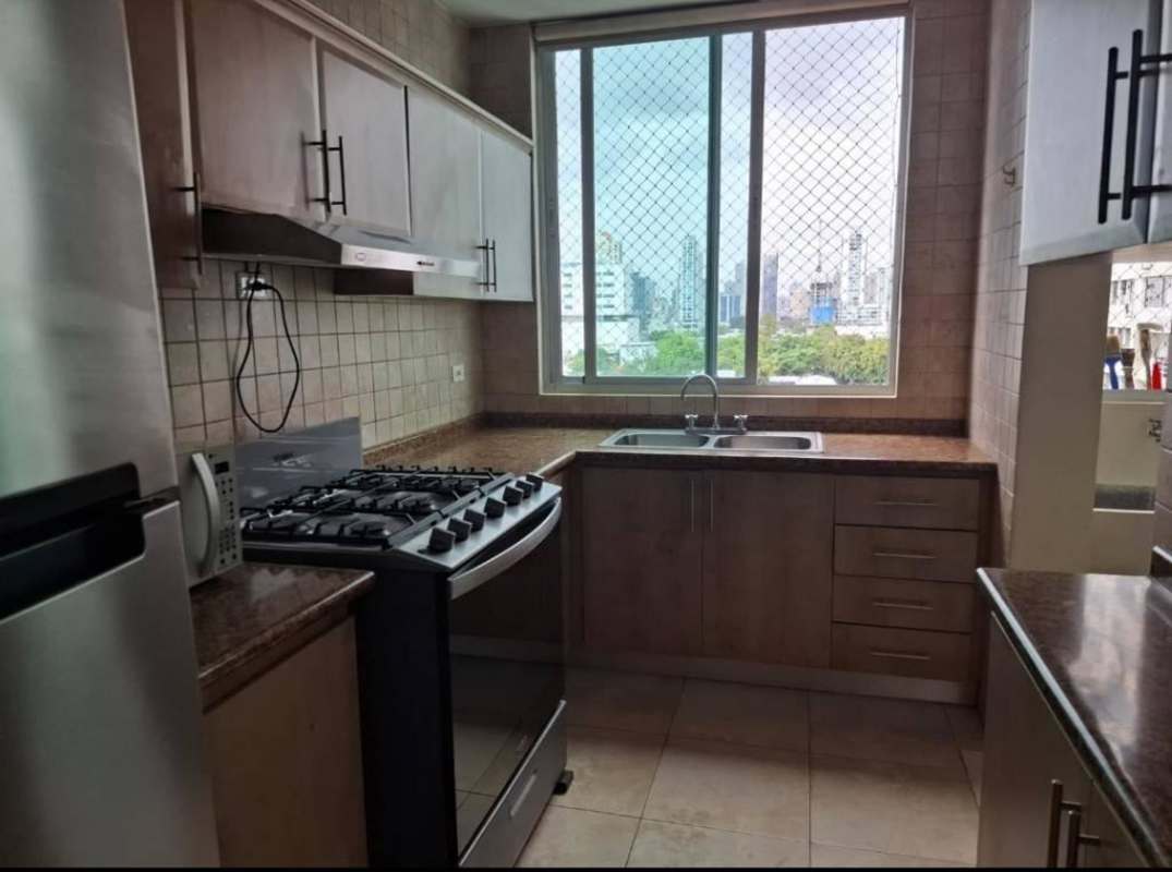 Kitchen with granite countertops, gas stove, large window with security mesh in PH San Francisco Bay Panama
