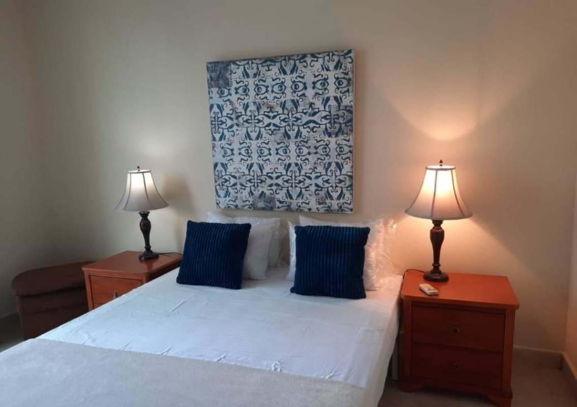 Bedroom with large window, city view, blue accents, air conditioning PH San Francisco Bay Panama City