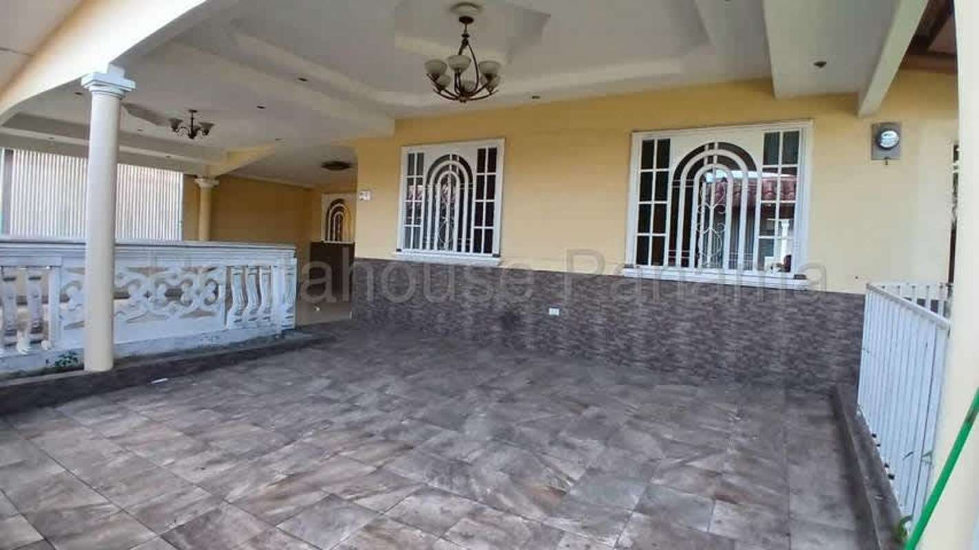Mediterranean style covered porch with tile flooring, decorative columns and security grills in Brisas del Golf Panama
