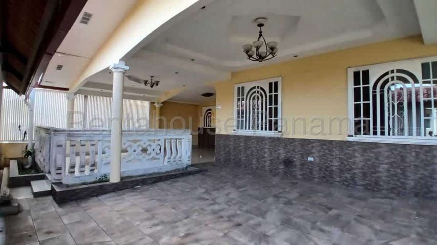 Large unfurnished kitchen space with tiled floor, big window and glass metal door in Brisas del Golf house Panama City