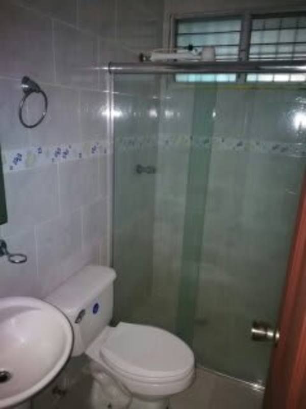 Bedroom with built-in closet and tile floors in San Antonio rental house Panama City.