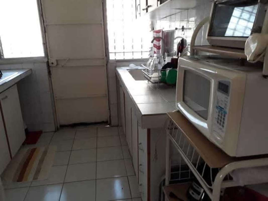 Spacious living area with natural light tiled floors large windows Betania house Panama