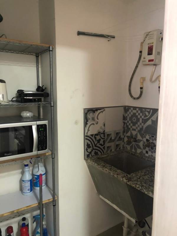Laundry space with sink, water heater, and storage loft apartment PH Vitro Loft El Cangrejo Panama
