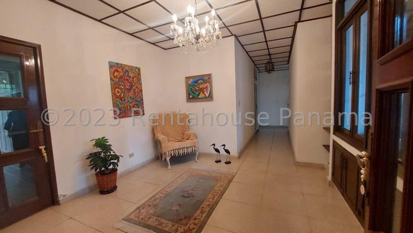 Colonial entrance hall with chandeliers, marble floors, decorative wall art in luxury house Panama City