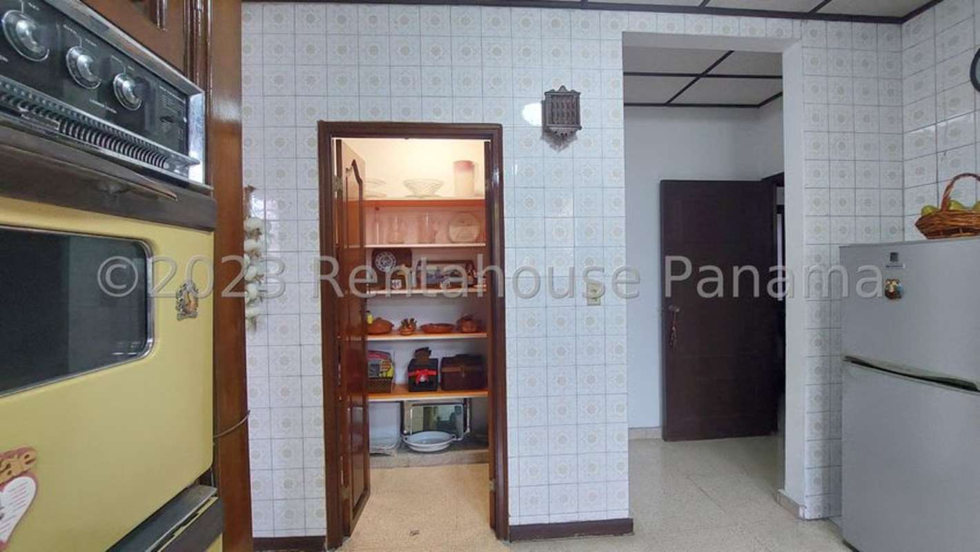 Vintage kitchen with built-in oven and pantry shelves in Altos de Golf house Panama