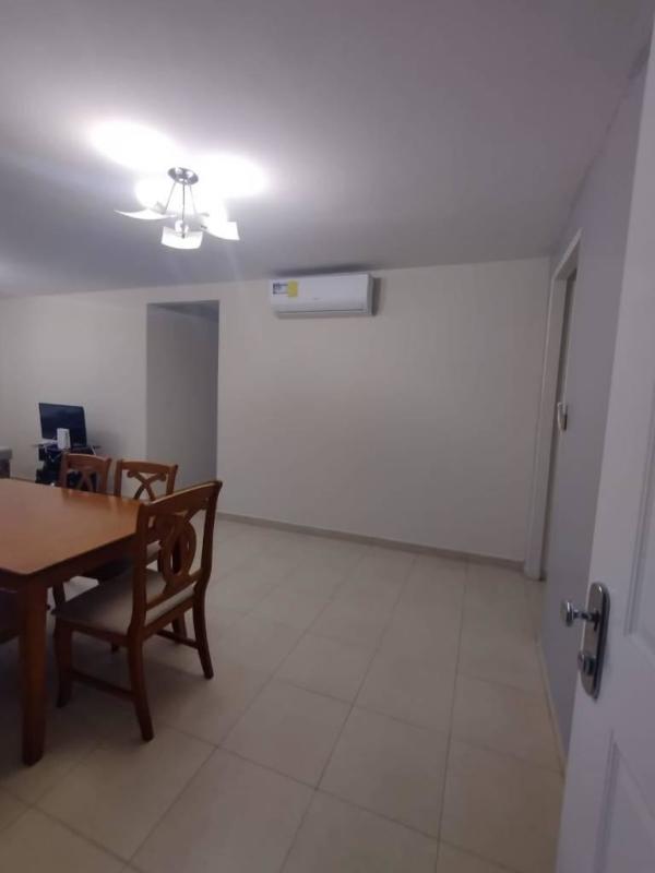 Dining room with AC unit, light fixture, and wood table in PH Torres de Versalles Panama City