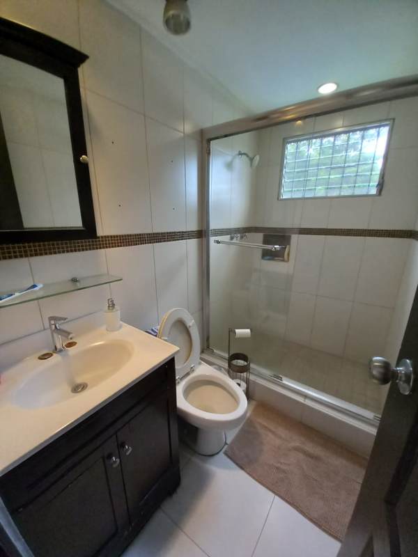 Modern bathroom with shower enclosure, ceramic tile, vanity in Las Cumbres house Panama