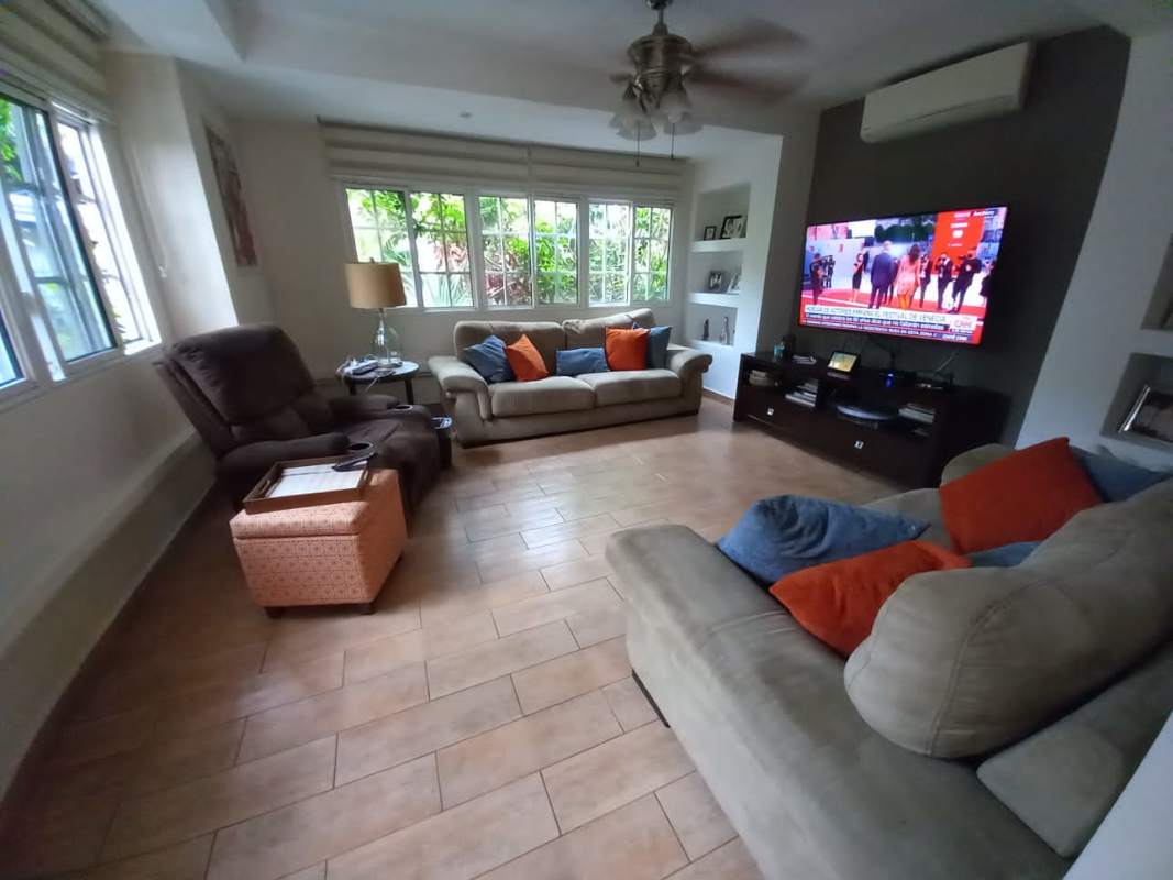 Landscaped garden patio with seating area, plants, columns Las Cumbres house Panama