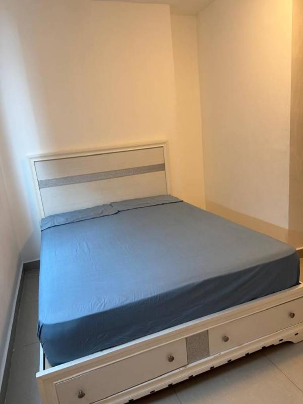 Bedroom with gray bed, blue bedding, large window, minimalist style in PH Diamond Panama City