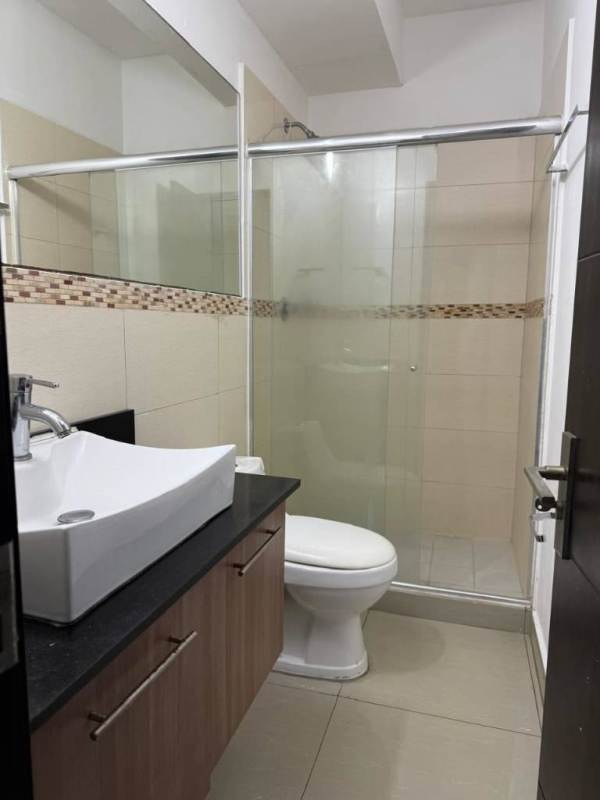 Modern bathroom with granite countertop, vessel sink, glass shower enclosure in PH Diamond Panama City