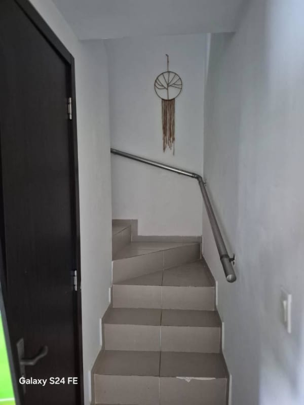 Minimalist staircase metal railing dreamcatcher decor inside Villasol house El Crisol Panama