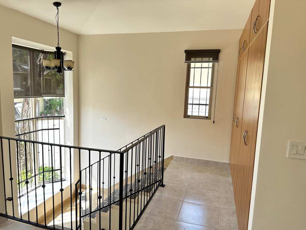 Upstairs landing with large window natural light and cabinets Embassy Gardens Clayton Panama rental house