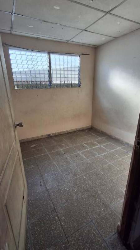 Small bedroom or storage with tiled floor and secure window in Las Acacias house Panama