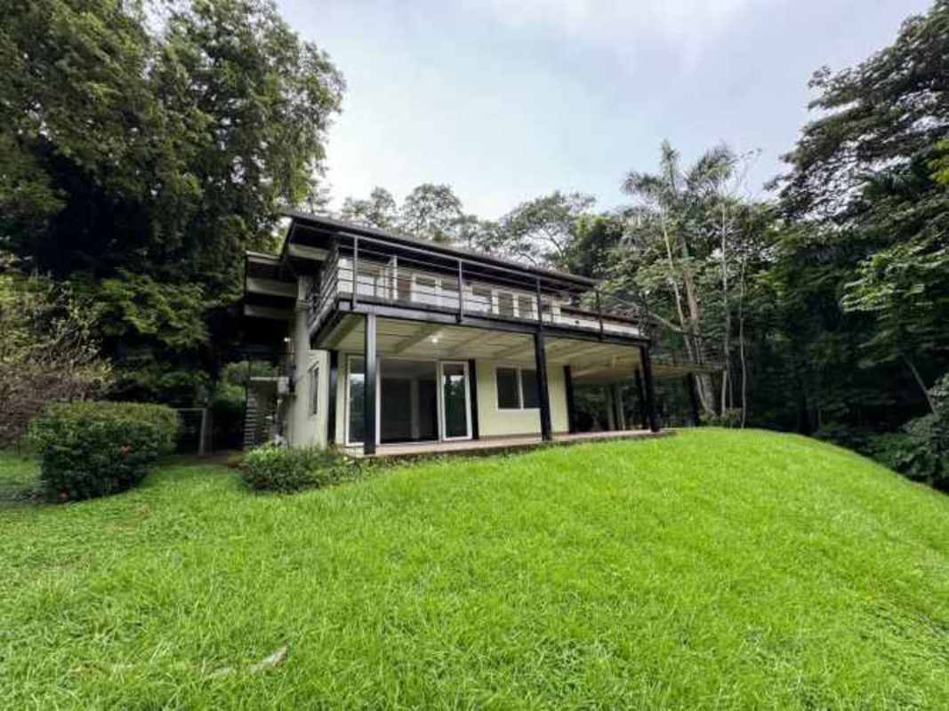 Modern hillside house with extensive balconies in lush green setting Ancón Panama