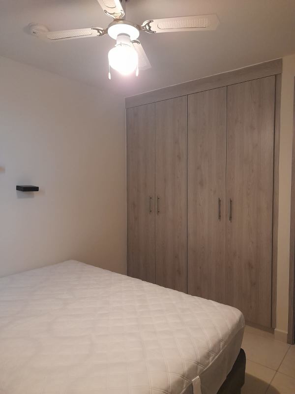 Bedroom with built-in wood wardrobe fan tile floors PH Torres de Versalles II Costa Sur Panama