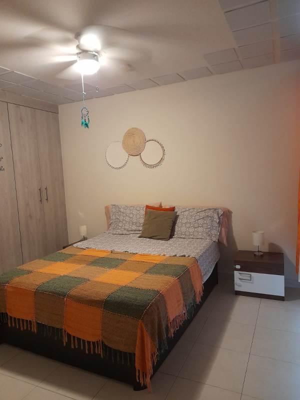 Bedroom with patchwork quilt wall mounted TV AC PH Torres de Versalles II Costa Sur Panama