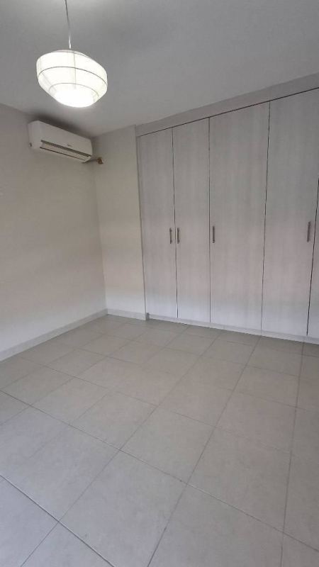 Bedroom with built-in closet and large window overlooking community in Torres de Versalles Don Bosco Panama