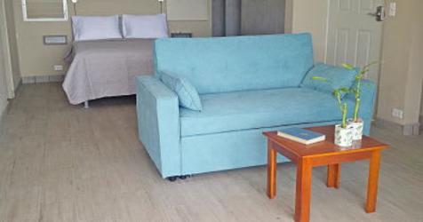 Two-story white beachfront house with tropical garden and balconies in Playa Corona