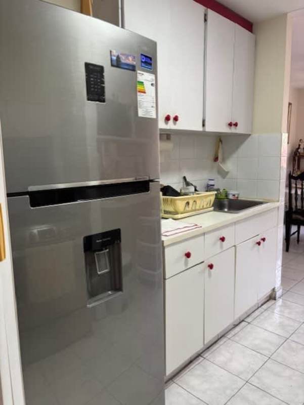 Kitchen with stainless refrigerator, microwave, brick red tile backsplash, gas stove in PH La Cresta Panama