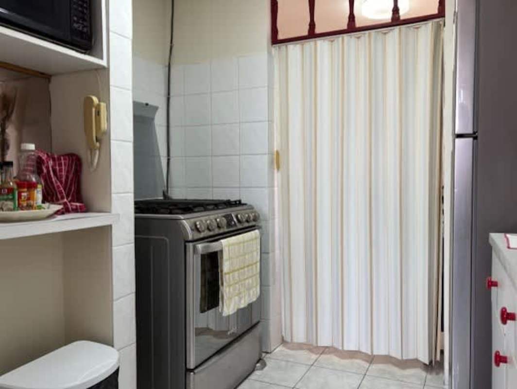 Stainless refrigerator, microwave, white cabinets kitchen apartment PH La Cresta Panama